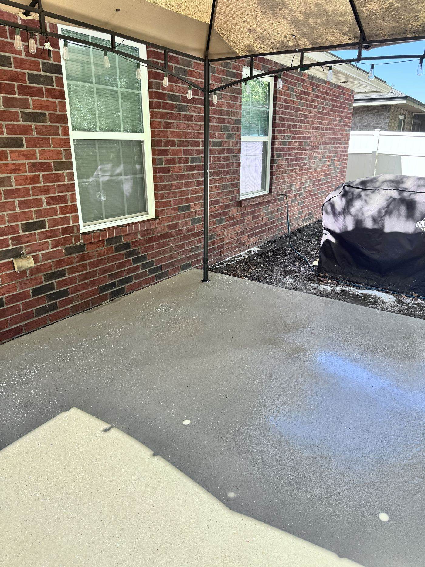 Patio concrete before cleaning, stained with mildew